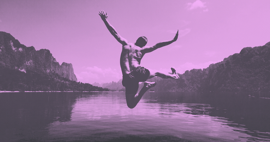 Man jumping into a lake